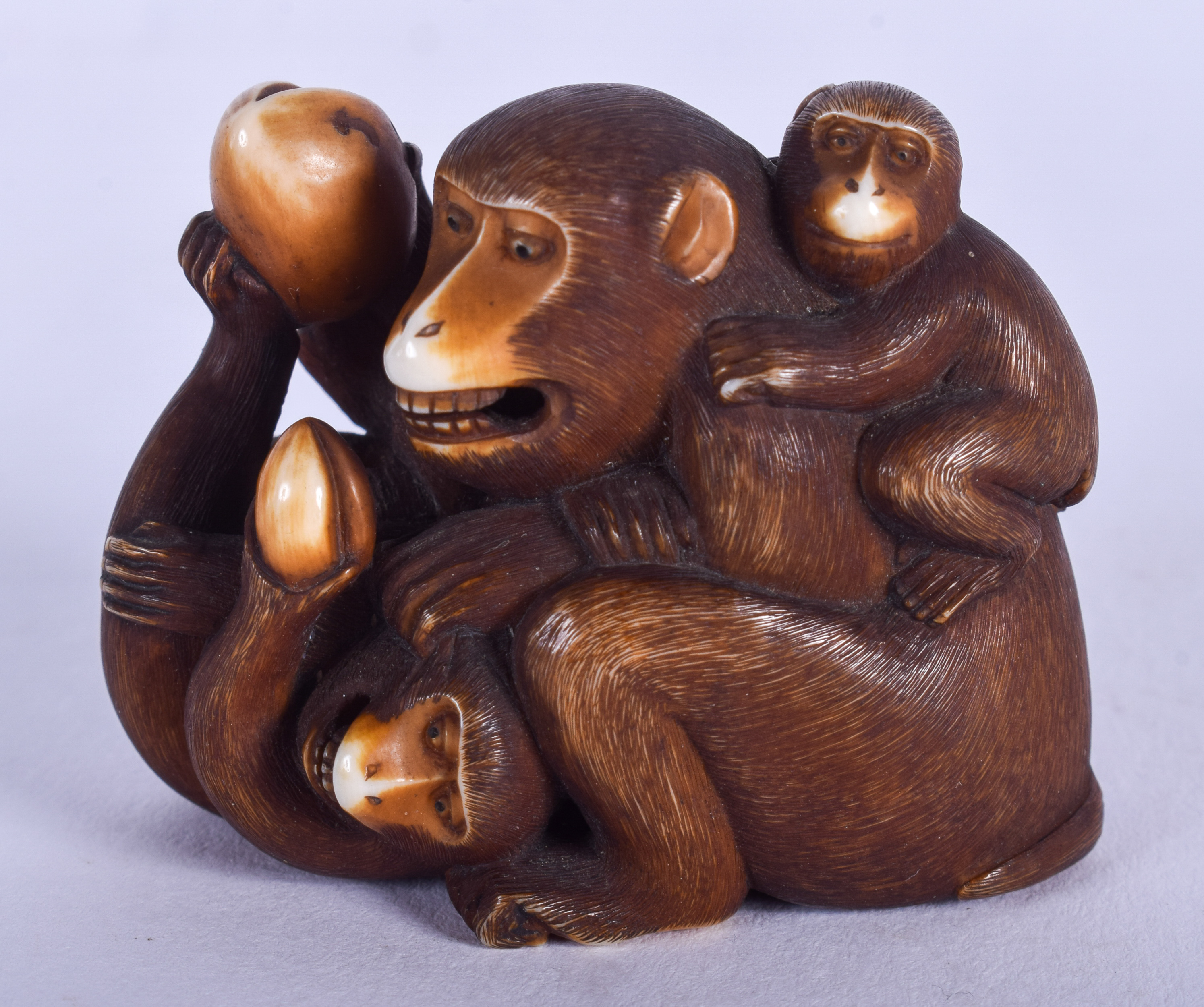 A FINE 19TH CENTURY JAPANESE MEIJI PERIOD STAINED IVORY OKIMONO modelled as grappling apes. 4 cm x