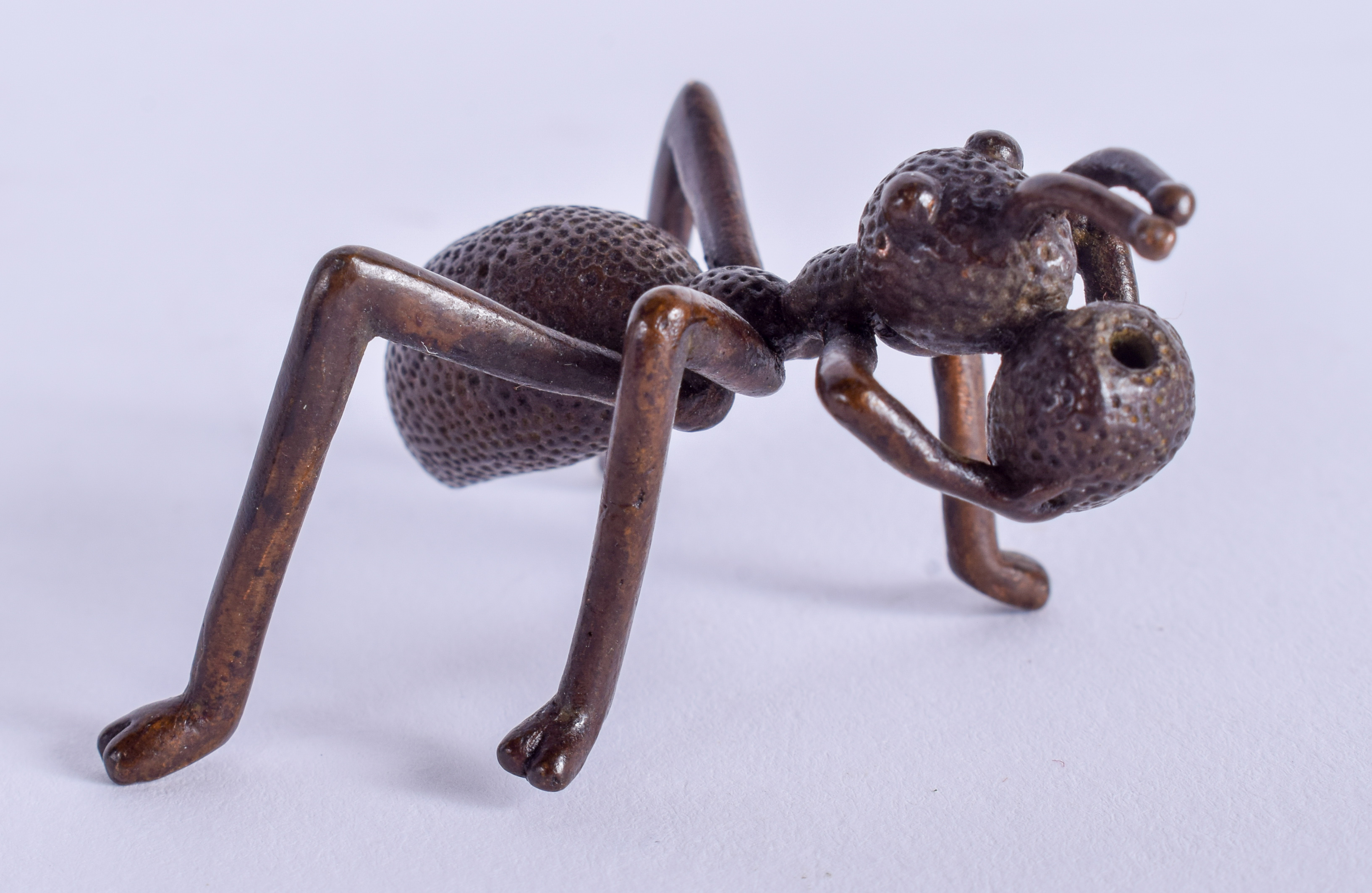 A JAPANESE BRONZE OKIMONO modelled as an ant. 6 cm wide.