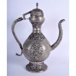 A LARGE INDIAN WHITE METAL KUFIC ISLAMIC COFFEE POT AND COVER decorated with birds and foliage. 35