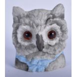 AN EARLY 20TH CENTURY BISQUE POTTERY OWL HEAD VASE, inset with amber coloured glass eyes. 10.5 cm h