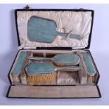 AN ART DECO SILVER AND SHAGREEN DRESSING TABLE SET within a fitted case. Largest 22 cm x 8 cm. (6)