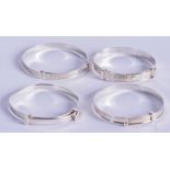 FOUR CHILDS SILVER BANGLES. 4.25 cm wide. (4)
