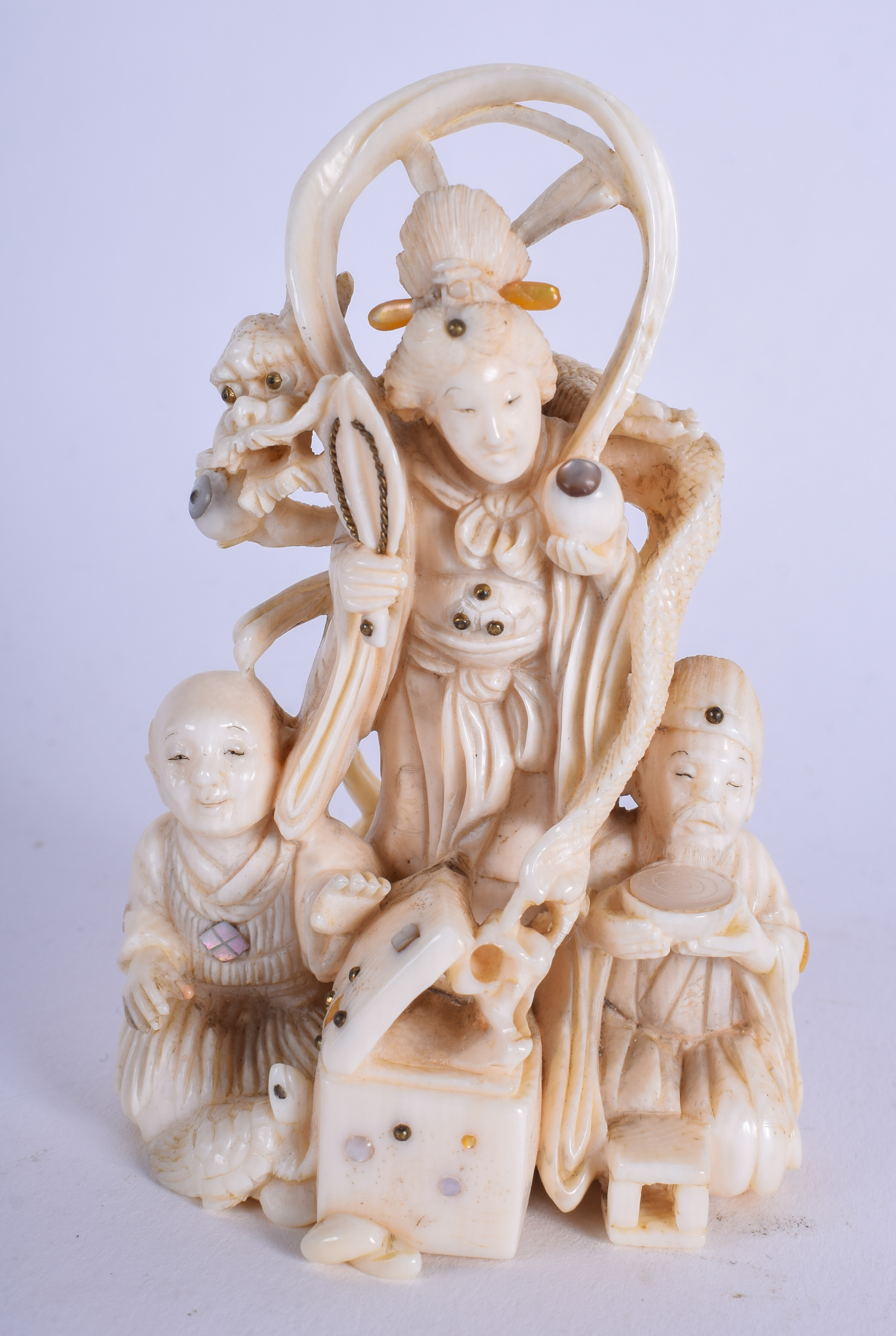 A 19TH CENTURY JAPANESE MEIJI PERIOD CARVED IVORY OKIMONO modelled as three scholars. 9 cm high.