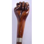AN ANTIQUE CARVED AND LACQUERED FIST WALKING CANE. 86 cm long.