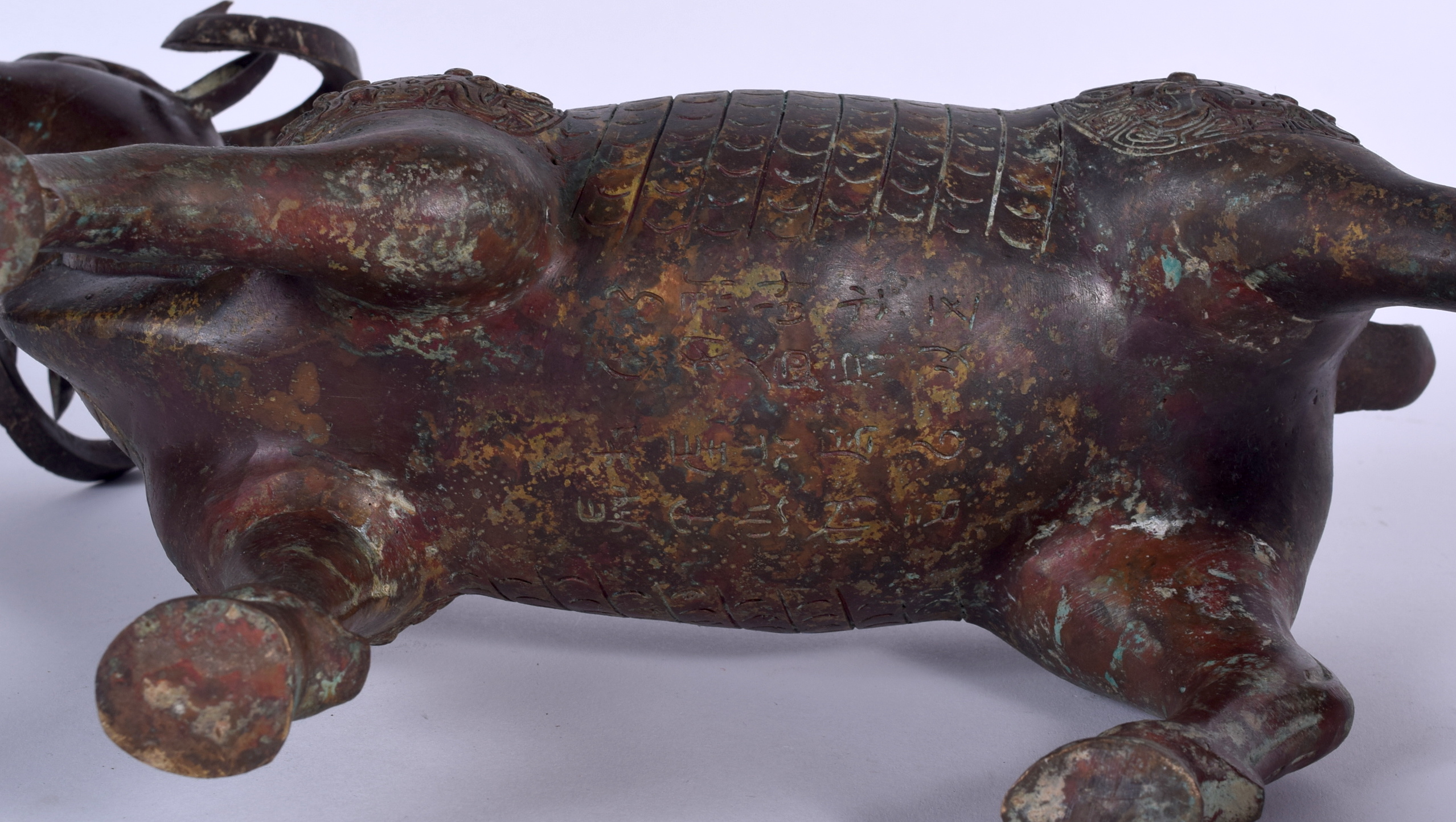 A LARGE CHINESE BRONZE STATUE OF A RAM, decorated with taotie mask heads. 29 cm x 35 cm. - Image 2 of 2