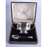 AN ART DECO TWIN HANDLED SILVER BOWL with matching spoon. Chester 1926. 5.5 oz. (2)