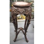 AN EARLY 20TH CENTURY CHINESE OCTAGONAL MARBLE INSET STAND carved with flowers. 91 cm x 36 cm.