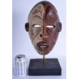 AN EARLY 20TH CENTURY AFRICAN TRIBAL CARVED WOOD MASK modelled as a male with an open mouth. Mask 2