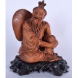 AN EARLY 20TH CENTURY CHINESE CARVED HARDWOOD FIGURE OF A MALE modelled seated. 18 cm x 11 cm.