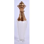 AN ANTIQUE FRENCH GOLD MOUNTED GLASS SCENT BOTTLE. 11 cm long.