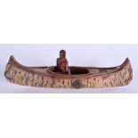 A VINTAGE CANADIAN NORTH AMERICAN CANOE with wooden armed attendant. 24 cm long.