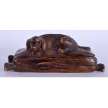 A 19TH CENTURY BAVARIAN BLACK FOREST HOUND SNUFF BOX modelled recumbent with glass eyes. 13 cm wide