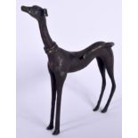 AN ABSTRACT BRONZE FIGURE OF A STANDING GREYHOUND, formed with elongated legs. 23 cm high.