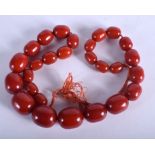 A CHERRY COLOURED BEAD NECKLACE. 120 grams. 74 cm long, largest bead 2.5 cm.