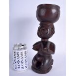 AN EARLY 20TH CENTURY AFRICAN TRIBAL FERTILITY FIGURAL HARDWOOD BOWL modelled as a kneeling female