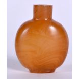 A CHINESE IMITATION AMBER AGATE SNUFF BOTTLE, formed with a flattened body. 5.5 cm x 4.75 cm.