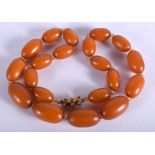 AN AMBER NECKLACE. 60 grams. 48 cm long, largest bead 2.5 cm wide.