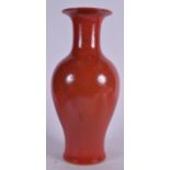 A CHINESE RED GLAZED PORCELAIN VASE BEARING KANGXI MARKS, baluster with a flared rim. 42 cm high.