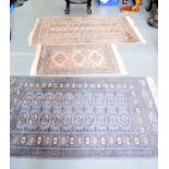 THREE BOKHARA RUGS, each decorated with geometric motifs, one signed. Largest 163 cm x 97 cm.