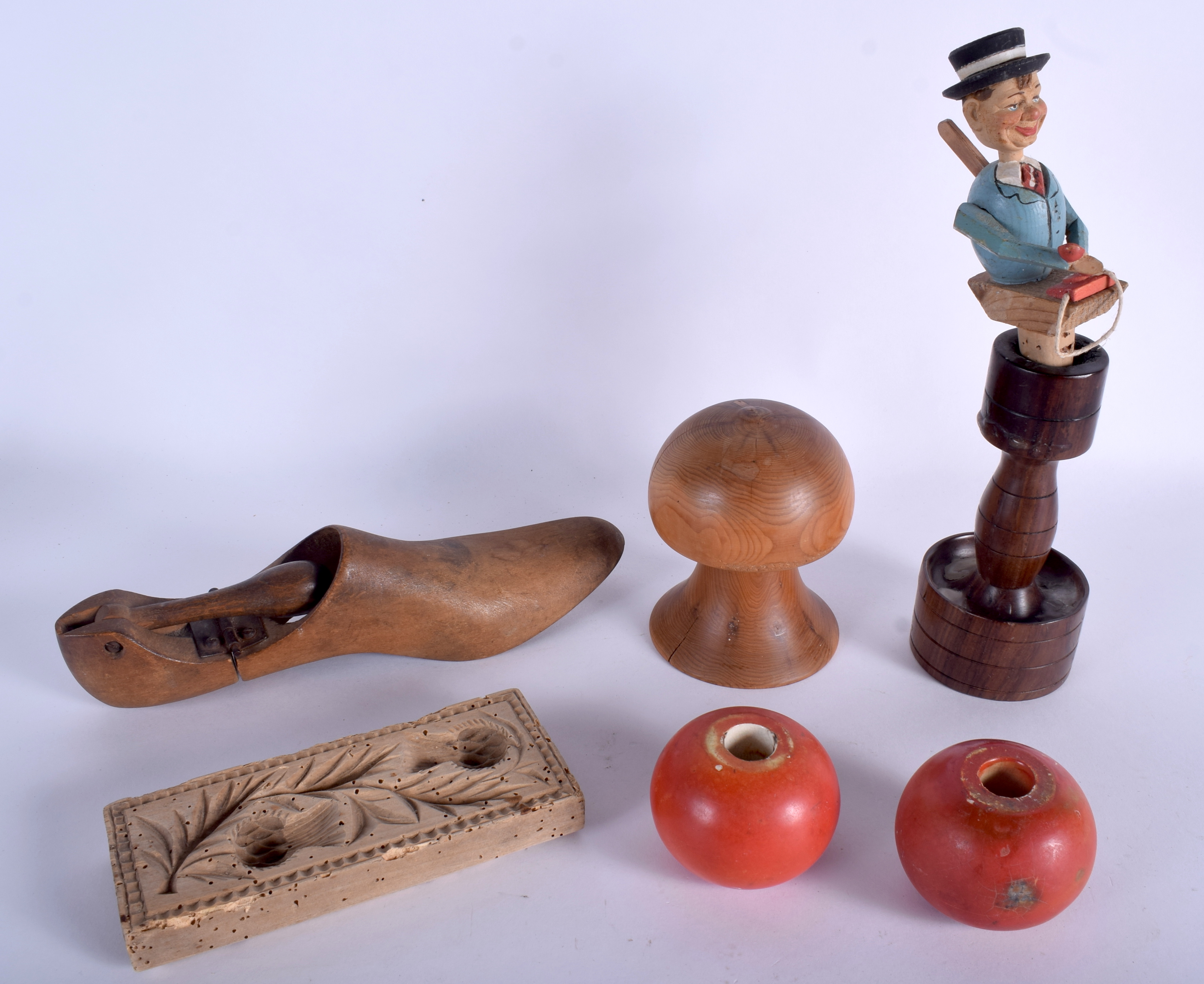 A VINTAGE NOVELTY BAVARIAN BLACK FOREST BOTTLE STOPPER together with unusual pottery toggles. (7)