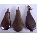 THREE ANTIQUE MILITARY POWDER FLASKS. Largest 22 cm long. (3)