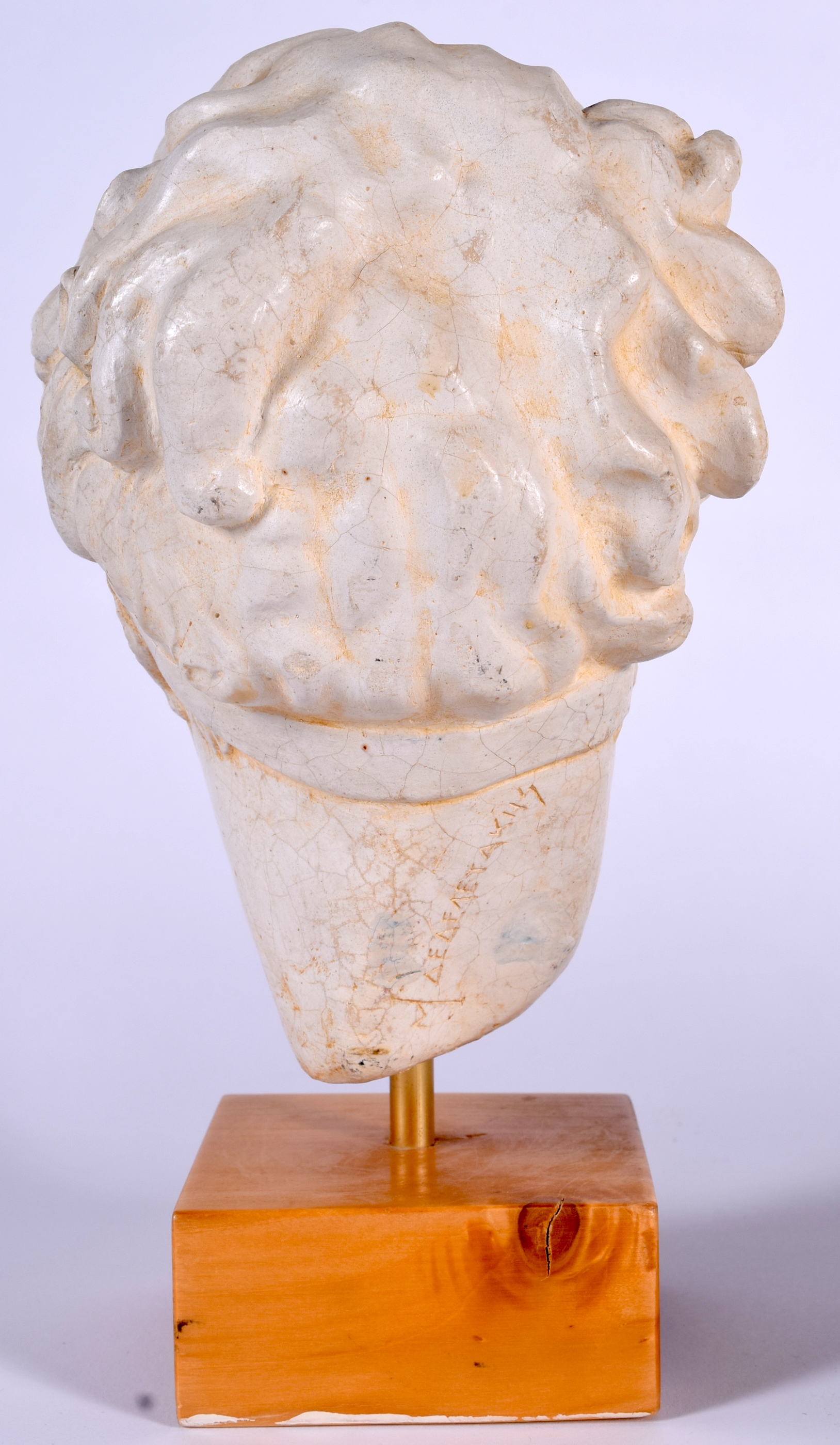 A GREEK PLASTER BUST OF A FEMALE, modelled upon a square wooden plinth. 29 cm high. - Image 2 of 2
