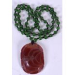 A APPLE GREEN HARDSTONE NECKLACE, formed with an agate pendant. 64 cm long.