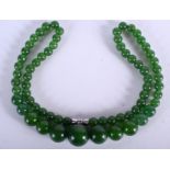 AN EARLY 20TH CENTURY CHINESE CARVED JADEITE NECKLACE. 44 cm long.