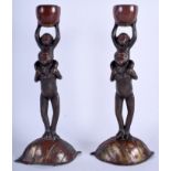A PAIR OF 19TH CENTURY JAPANESE MEIJI PERIOD BRONZE AND SPELTER CANDLESTICKS formed as standing ape