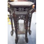 A 19TH CENTURY CHINESE HEXAGONAL HARDWOOD MARBLE INSET STAND carved with mask heads and foliage. 71