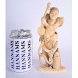 A 19TH CENTURY JAPANESE MEIJI PERIOD CARVED IVORY OKIMONO modelled as a musician beside snakes. 20