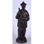 A CHINESE BRONZE STATUE OF A STANDING MALE, modelled standing upon a naturalistic base. 33 cm high.