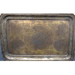 A LARGE ISLAMIC METAL TRAY, decorated with script and foliage. 60 cm wide.