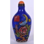 AN IMITATION LAPIS CHINESE GLASS SNUFF BOTTLE, overlaid with birds amongst foliage and bearing Qian