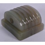 A CHINESE CARVED JADE SEAL, formed with a ribbed terminal. 4.25 cm wide.