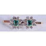 AN ANTIQUE 9CT GOLD DIAMOND AND EMERALD BAR BROOCH. 3.5 grams. 3.25 cm wide.