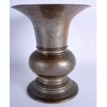A 19TH CENTURY INDIAN EASTERN BRONZE ALLOY VASE upon a circular stepped foot. 28 cm high.