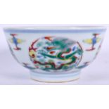 A CHINESE DOUCAI PORCELAIN BOWL BEARING YONGZHENG MARKS, decorated with dragons amongst the clouds.