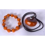 AN AMBER BOULDER NECKLACE, together with an amber type spherical bead bracelet. Boulder 5.25 cm wid