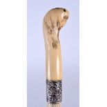 AN EARLY 20TH CENTURY IVORY TOP WHALE BONE WALKING CANE, the terminal in the form of a serpent head