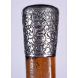 A SOLID SILVER TOP WALKING CANE, decorated with extensive foliage. 85 cm long.