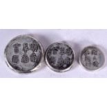 THREE CHINESE WHITE METAL BUTTONS, decorated with calligraphy. Largest 2.9 cm. (3)