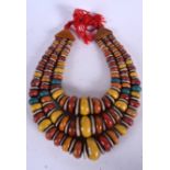 A THICK MOROCCAN DOUBLE STRAND NECKLACE, formed with flattened beads. 84 cm long.