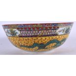 A MID 20TH CENTURY CHINESE FAMILLE JAUNE PORCELAIN BOWL, painted with dragons. 26 cm wide.