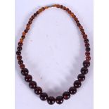 AN AMBER TYPE NECKLACE, formed with spherical beads. 56 cm long.