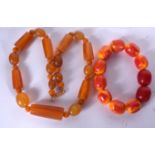 AN AMBER TYPE NECKLACE, together with a similar bracelet. Necklace 44 cm long. (2)