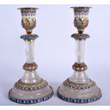 AN UNUSUAL PAIR OF CONTINENTAL ROCK CRYSTAL CANDLESTICKS overlaid with silver and enamel. 20 cm hig