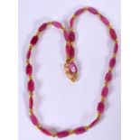 A PINK HARDSTONE NECKLACE, formed with yellow metal spacers. 42 cm long.