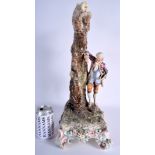 A LARGE ANTIQUE AUSTRIAN POTTERY FIGURAL GROUP depicting a male resting beside a tree. 47 cm x 32 c