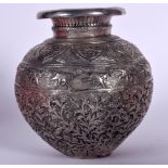 AN ISLAMIC WHITE METAL GLOBULAR VASE, decorated in relief with elephants and extensive foliage. 21